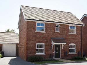 a red brick house with a garage at Pass the Keys Beautiful Family Home Sleeps 6 in Emsworth