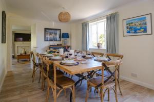 a dining room with a wooden table and chairs at 9 The Coastguards in Thorpeness