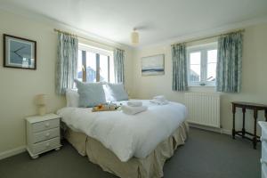a bedroom with a large bed with towels on it at 9 The Coastguards in Thorpeness