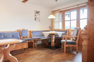 a dining room with a table and chairs at Haus Ranker in Reit im Winkl