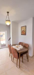 a dining room with a wooden table and chairs at Villa Plaj in Kusadası