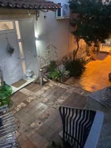 a patio with a zebra chair in front of a house at Il Giardino d'Ulisse in Reggio di Calabria