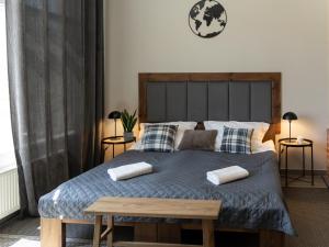 a bedroom with a bed with two pillows on it at Apartament MT Badger Centrum in Ustrzyki Dolne