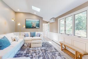 a living room with white furniture and windows at Bourne Glen in Bourne