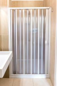 a shower with a sliding glass door in a bathroom at SE005 - Senigallia, trilocale sul mare con spiaggia in Senigallia