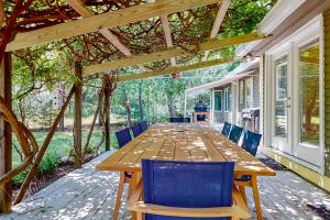 a long wooden table and chairs on a patio at Bourne Glen in Bourne