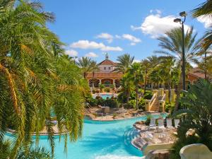 a resort with a swimming pool and palm trees at Regal Palms Lovely 3 Br Sleeps 8mins To Disney in Davenport