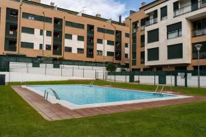 an empty swimming pool in front of a building at La Figar,apartamento con piscina, playa a 3km VUT-4390-AS in Llanes