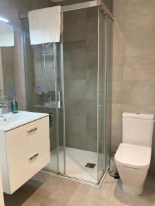a bathroom with a shower with a toilet and a sink at CP luxury studio in Gibraltar
