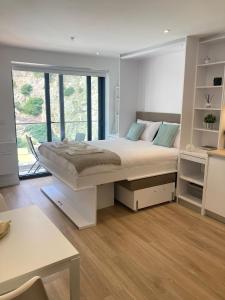 a bedroom with a large bed with a large window at CP luxury studio in Gibraltar