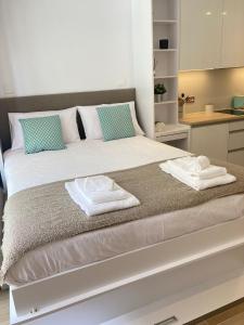 a bedroom with a large bed with towels on it at CP luxury studio in Gibraltar