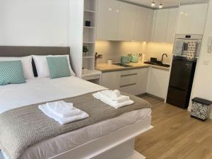 a bedroom with a large bed with towels on it at CP luxury studio in Gibraltar +6 photos