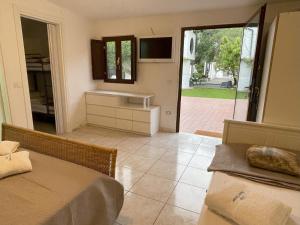 a room with two beds and a view of a patio at Villa Avvocato Catapano in Pontecagnano