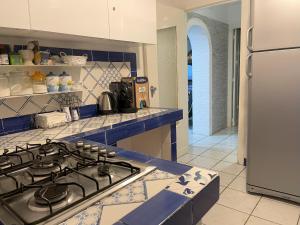 a kitchen with a stove top and a refrigerator at Villa Avvocato Catapano in Pontecagnano