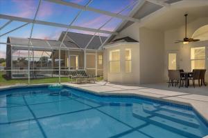 a swimming pool in a house with a glass ceiling at Amazing 4 Bedrooms 3 Bath with private pool, near Disney and Universal! in Davenport