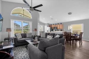 a living room with a couch and a dining room at Amazing 4 Bedrooms 3 Bath with private pool, near Disney and Universal! in Davenport