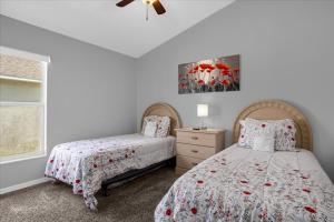 a bedroom with two beds and a window at Amazing 4 Bedrooms 3 Bath with private pool, near Disney and Universal! in Davenport +29 photos