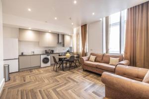 a living room with a couch and a table at The Pocklington - The Guild Suite in Leicester