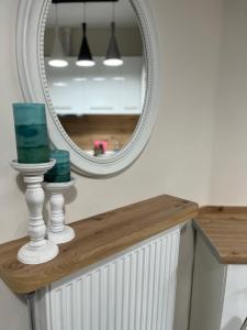 a mirror sitting on top of a counter in a bathroom at Studio Coral by the sea in Neoi Epivates