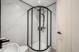 a shower in a bathroom with a toilet and a sink at New York Living in Yorkshire - Sleeps 4 in Castleford