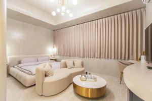a bedroom with a bed and a couch and a table at ART BnB in Tainan