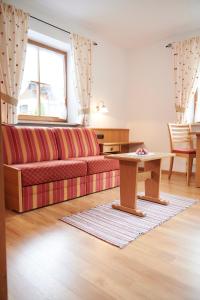 a living room with a couch and a table at Haus Sonnwies in Reit im Winkl +34 photos