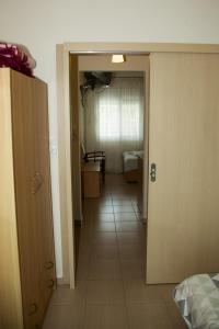 a hallway leading to a room with a bedroom at Assa Inn in Pyrgadikia