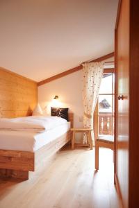 a bedroom with a large bed and a window at Haus Sonnwies in Reit im Winkl