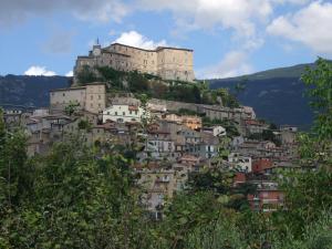 a castle on top of a hill with houses at Il casale di Pino e Rita in Subiaco