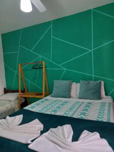 Postel nebo postele na pokoji v ubytování Villa dos Pássaros Paraty Hospedagem