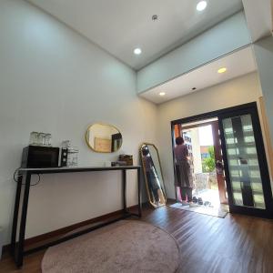 a person standing in a room looking out the door at Onthestone Pension in Seogwipo +88 photos