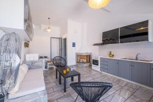 a kitchen and living room with a couch and a table at Sterna house in Parasporos