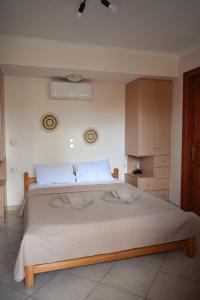 a bedroom with a large bed in a room at Tranquil Apartments in Naxos Chora +12 photos