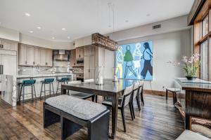 a kitchen and dining room with a table and chairs at Bachelor Gulch Horizon Pass Private Townhome in Beaver Creek
