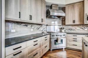 a kitchen with white cabinets and a stove at Bachelor Gulch Horizon Pass Private Townhome in Beaver Creek