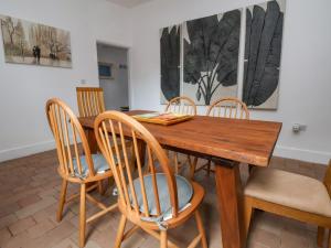 a dining room with a wooden table and chairs at Oneofour in Chester