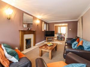 a living room with a couch and a fireplace at 23 Brandeston Close in Sudbury