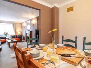 a dining room with a table with food on it at 23 Brandeston Close in Sudbury