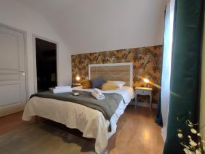 a bedroom with a large bed in a room at Auberge des Colettes in Coutansouze