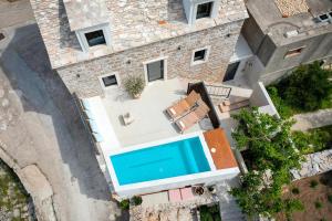 an aerial view of a house with a swimming pool at She House - built for pleasure - Island of Brač in Gornji Humac