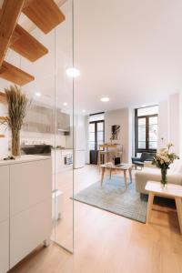 a kitchen and living room with glass walls at San Bernardo, 19 in Avilés