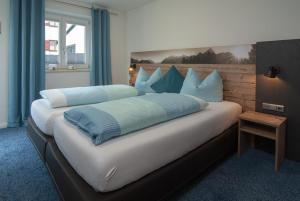 Postel nebo postele na pokoji v ubytování Eldorado - Ferienwohnungen & Suiten