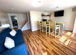 a living room with a blue couch and a kitchen at Beautiful Boathouse overlooking the Bay in Sandusky