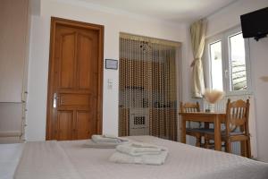 a bedroom with a bed with towels on it at Tranquil Apartments in Naxos Chora