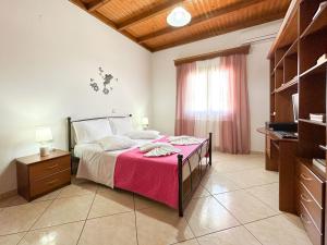 a bedroom with a bed with a pink blanket at Villa Limoncello in Agrafoí +27 photos