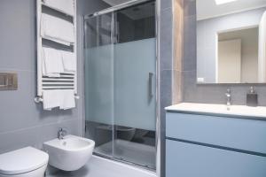 a bathroom with a shower and a toilet and a sink at Viam Imbriani Suites in Rome