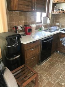 a kitchen with a stove and a sink at Rustic Modern Patio Home With Shared Pool in Kırıkyayla