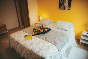 a bedroom with a bed with a bouquet of flowers on it at Eco Pousada Estrelas da Babilônia in Rio de Janeiro