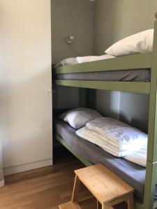 a room with two bunk beds and a wooden table at Joarsbo, Stuga 3, Klinten in Kalv