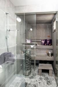 a bathroom with a glass shower and a sink at Villa Vivante in Porvoo